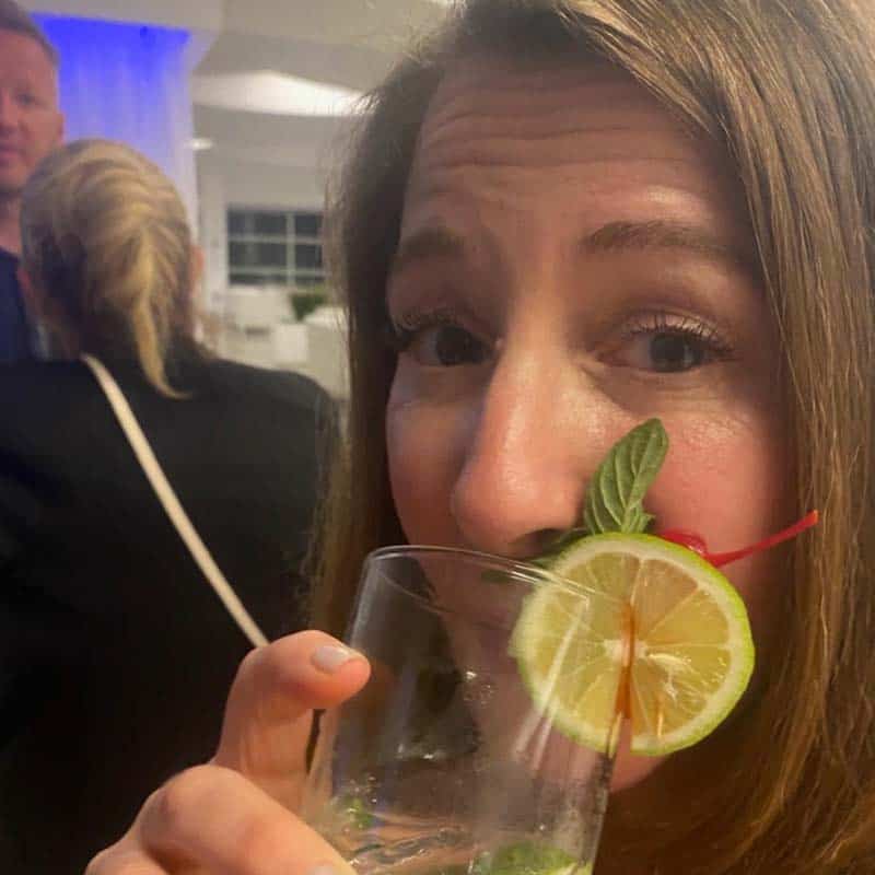 Woman with drink in front of face